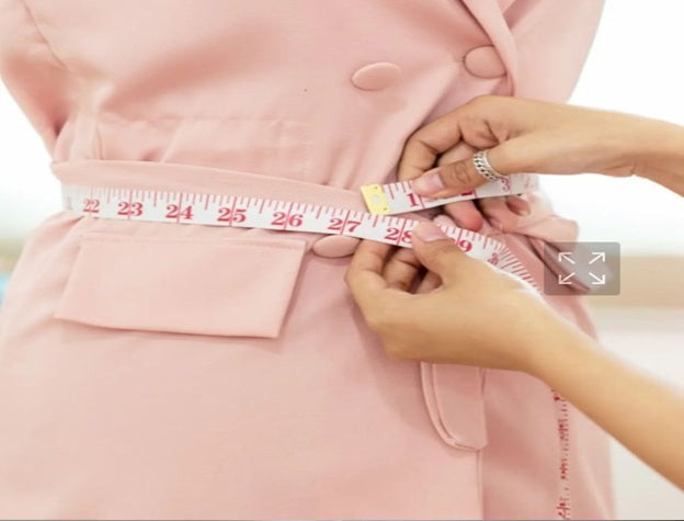 Client consultation with lady tailor for gown adjustments